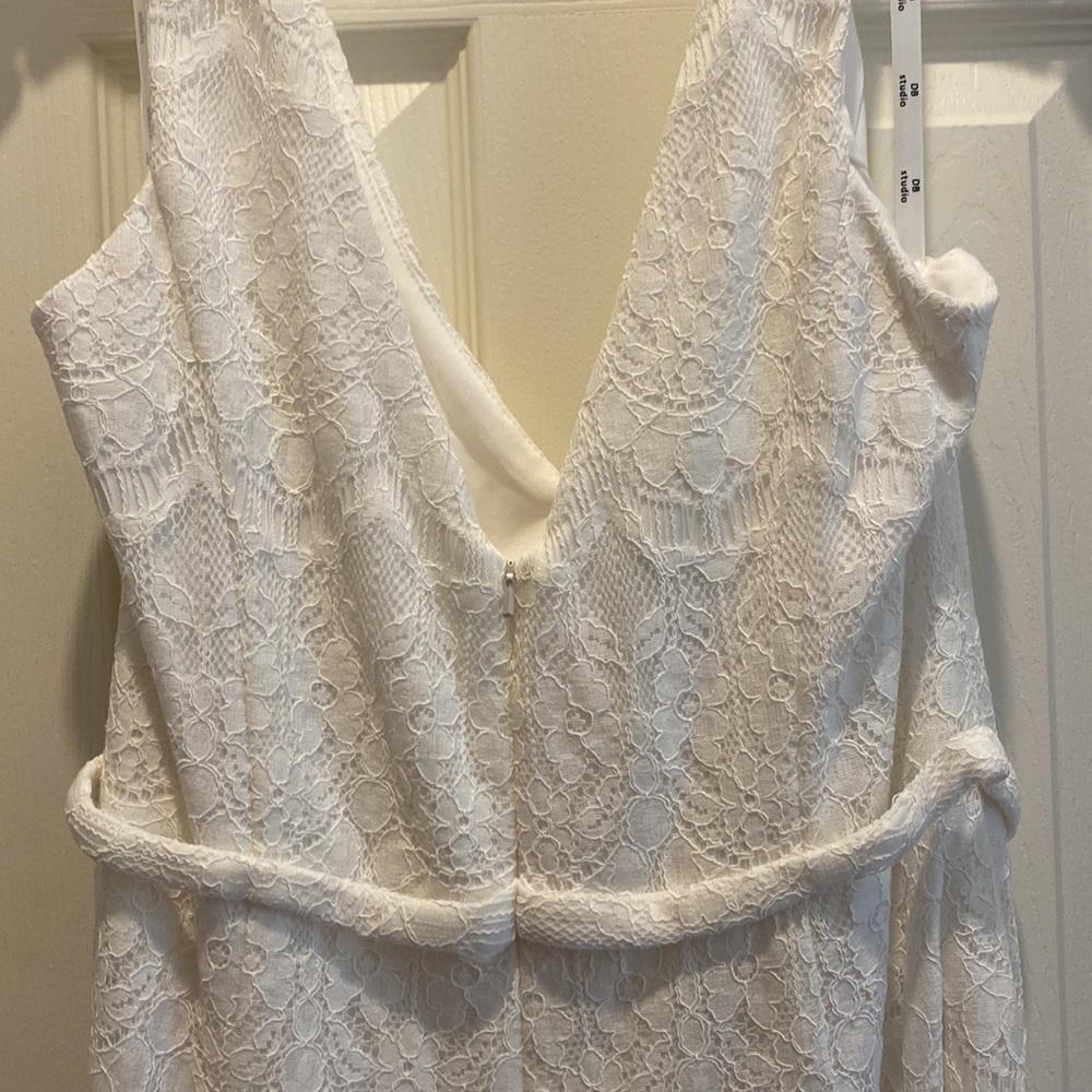 Never worn. This DB Studio white lace jumpsuit is in perfect condition.
